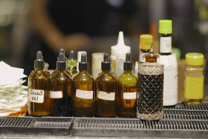 Various bottles of liquids on a bar counter.